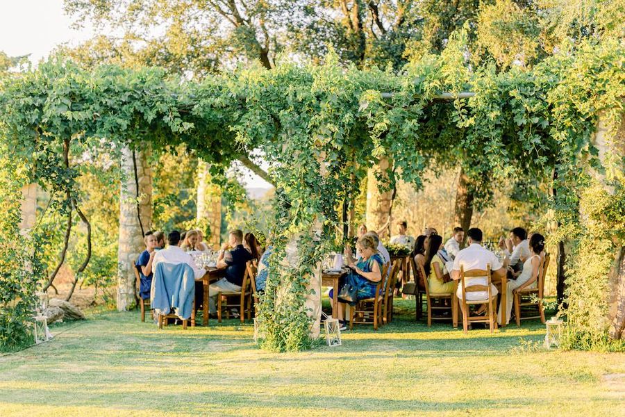tourists standing and tasting wines in the garden with stone columns–Gastronomy Tours.JPG